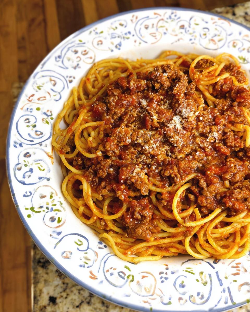 A hearty bowl of spaghetti with a rich ground beef bolognese sauce, a perfect example of best ground beef recipes for busy nights.